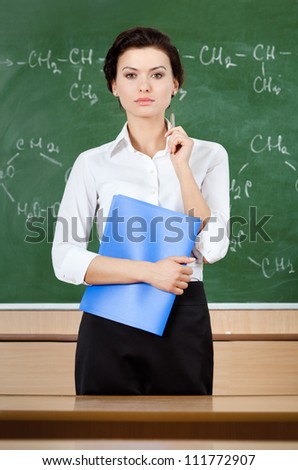Smiley teacher at the blackboard