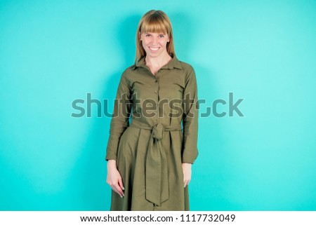 blonde woman in studio on blue background