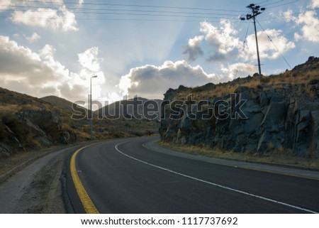 bueatiful curved road With cloudy sky and hills, Located in Banisad, Saudi arabia
