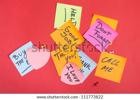 Collection of adhesive notes on red background