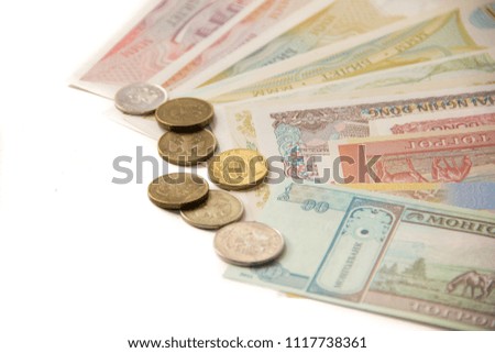 Paper money and coins on a white background