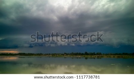 Storm clouds before the rain and colorful dramatic sky at sunset before storm in evening have reflection of water in Lake for nature smooth skyscape photography background.Landscape Nature HDR Tone.