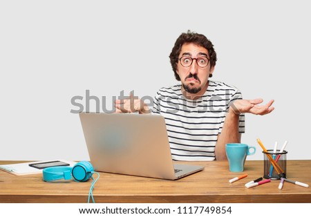 young bearded graphic designer with a laptop  Royalty-Free Stock Photo #1117749854