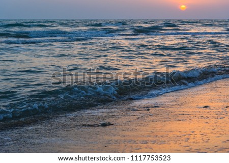Sunset over the sea on wild beach of Persian gulf coast. Bushehr Province. Iran
