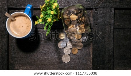 Time to SAVING concept with stack of coin on dark wooden table. business and financial concept idea. Selective focus