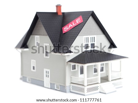 Real estate concept - home architectural model with sale sign, isolated