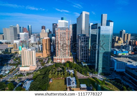 Houston Texas skyline cityscape modern urban skyscrapers rising up along gulf coast Texas city aerial drone view high above green park with solar panels and renewable sustainable living