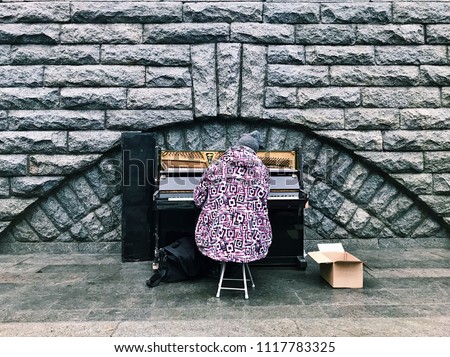 A homeless man plays an outdoor piano in Kiev, Ukraine.