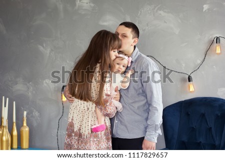 Father, mother and their daughter in the room/
