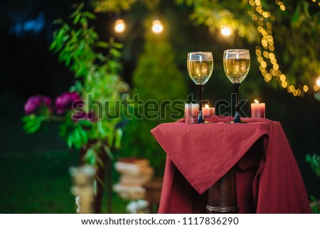 photo of two glasses of champagne on a table with a bokeh background