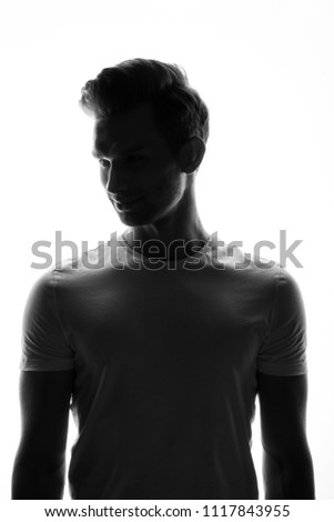 Silhouette of young man portrait in shirt with hand on studio isolated white background. Close up.