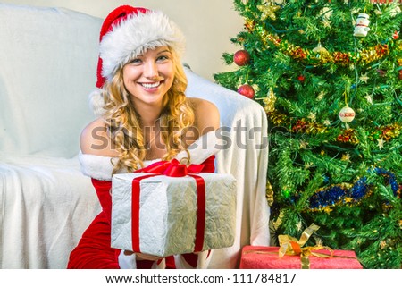 Smiling beautiful young woman giving a gift
