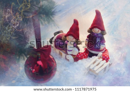 two girls with sled looking at a Christmas tree