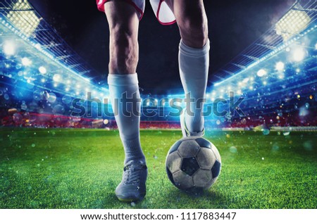 Soccer player ready to kick the soccerball at the stadium during the match