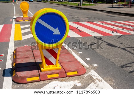 plastic car sign near a pedestrian crossing on the road on a sunny day
