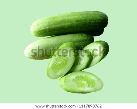 Cucumber cut isolated on green background