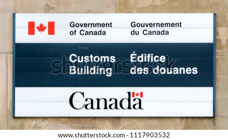 A Customs Building sign on a Government of Canada building. Closeup view.