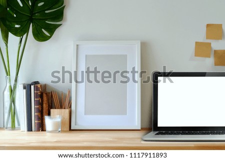 Minimal workspace mockup poster and laptop on studio desk.
