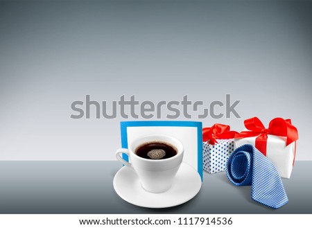 Image of shopping bag, bow tie and cup of coffee, present for dad. Father's day concept