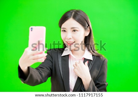 businesswoman selfie happily on the green background