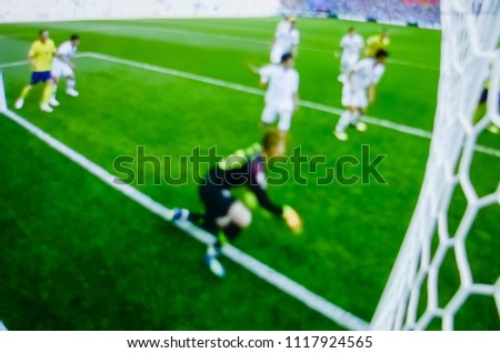 The blur background of football,Blurred crowd of spectators on a stadium with an action in football match.