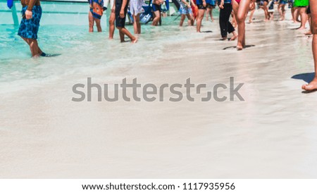 Panorama white sandy for background with blurred legs of group traveler or tourist people joy walking on tropical sea beach, Crop for banner summer holiday vacation travel concept, Tourism Asia beach