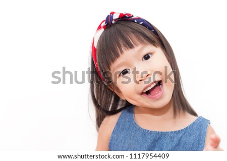 Closeup portrait of little asian girl wearing head band American Flag isolated on white background. Celebration of idependent day fourth of July american people memorial day holiday concept