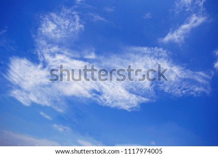 The vast sky and the white clouds float in the sky. The natural blue background has a breeze on a bright day in the summer.The sky and the clouds are shaped like the dragon lion of China.