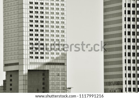  Modern office building wall made of steel and glass. Black and white.