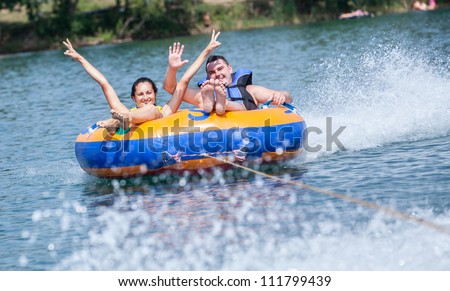Young couiple on water attractions during summer vacations Royalty-Free Stock Photo #111799439