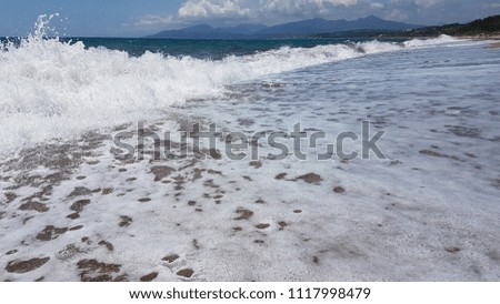 waves splash foam in summer sea Preveza Greece