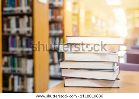 Education learning concept with opening book in old library, isle of bookshelves in school study class room background