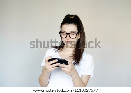 portrait of a young woman, enjoying a smartphone