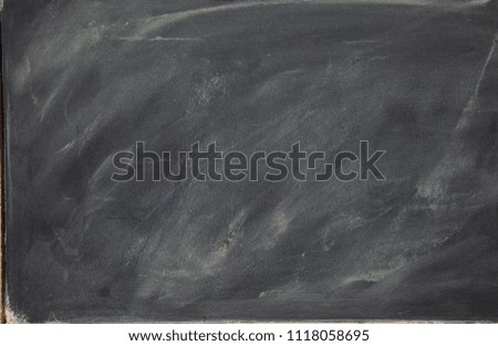 BLACK TABLE WITH TRACES OF CHALKS