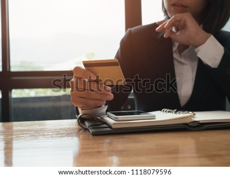 Young asian business woman using credit card pay for business expenses in meeting room.
