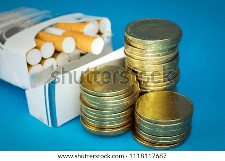 Tobacco  Cigarettes Taxes concept. Cigarettes  money gold coins