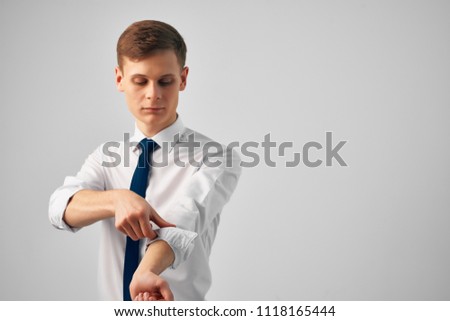 man with a tie roll up his sleeves                            