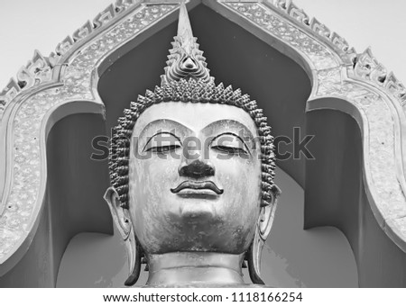 Clos up of Face statue Buddha in Thailand, Buddha statue used as amulets of Buddhism religion. This image was blurred or selective focus. Black and white picture.