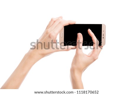 Hand holds a smartphone on a white background
