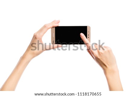 A hand holds a smartphone on a white background. Shows on smartphone display