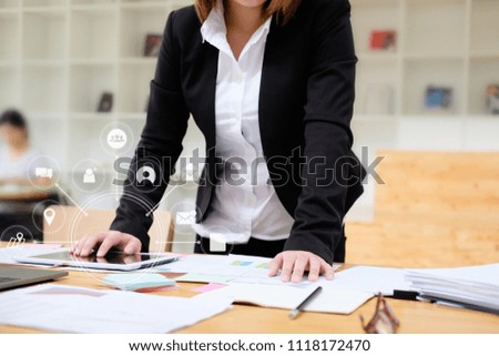 Business woman working with tablet computer analysis data of finance and visual icon technology.