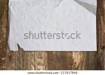 Crumpled old paper on a wooden background