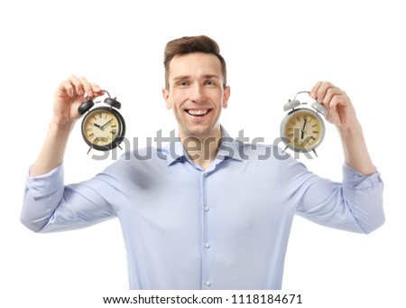 Successful businessman with alarm clocks on white background. Time management concept