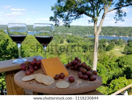 Wine Tasting Icon with Cheese and Grapes on a Serving Plate and Panoramic Water View Background Royalty-Free Stock Photo #1118230844