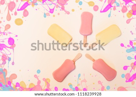 Ice cream on sticks on pastel background
