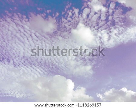 Pastel violet and blue sky background with white clouds. (space for text, article layout design)