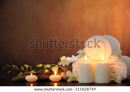 Spa still life with aromatic candles,orchid flower and towel. Royalty-Free Stock Photo #111828749