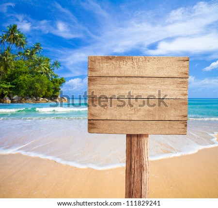wooden signboard on tropical beach