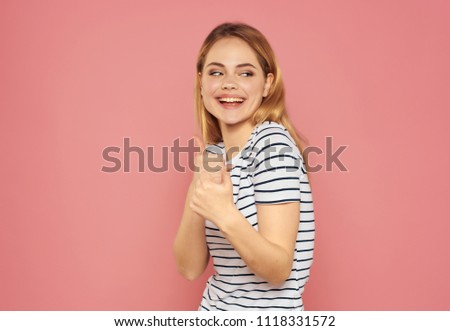 Pink background and blonde in a striped T-shirt                     