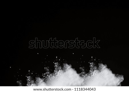 White Powder explosion on black background. White dust exploding.Paint Holi
